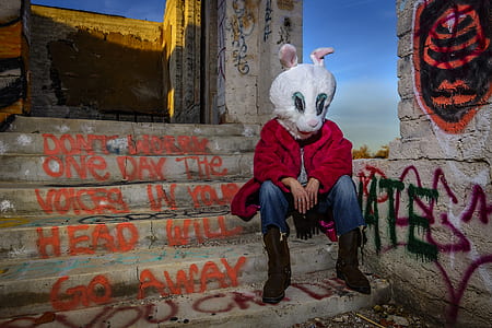 photo of man sitting and wearing rabbit mask thumbnail