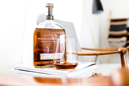 selective focus photography of Woodford bottle near clear drinking glass on wooden table thumbnail