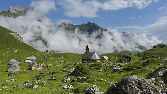 brown and gray concrete houses on grass field photo thumbnail