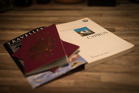 two maroon passports on book thumbnail
