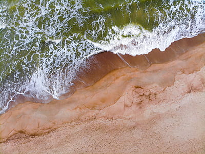 aerial shot of waves on shore thumbnail