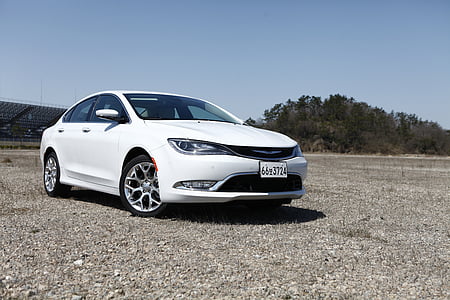 white Chrysler 200 sedan parked on soil pavement thumbnail