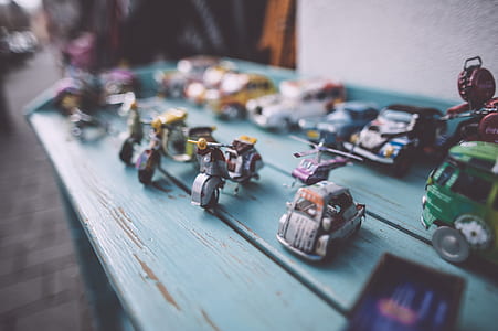 assorted-color vehicle scalemodel collection on teal wooden surface thumbnail