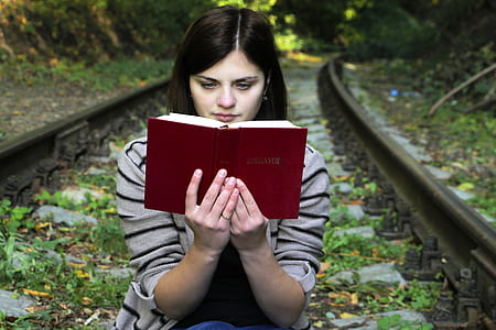Young Woman Sitting on Bench in Park thumbnail