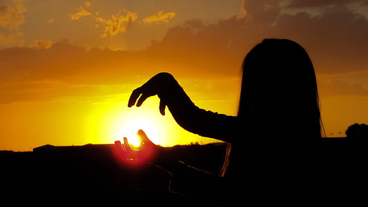 silhouette of girl stands during sunset thumbnail