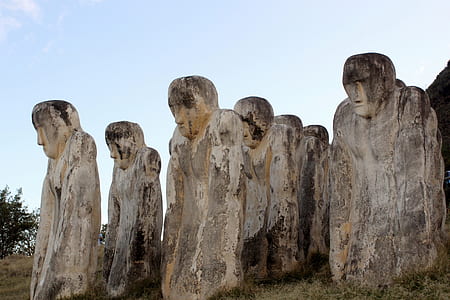 human form stone statue on field thumbnail