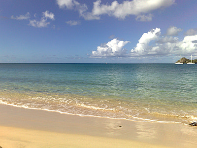 seashore near island under blue sky thumbnail