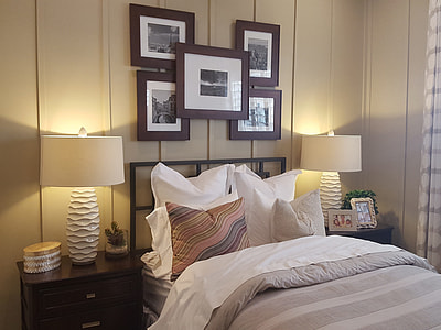 white and grey bedspread with two nightlights on both sides of the bed thumbnail