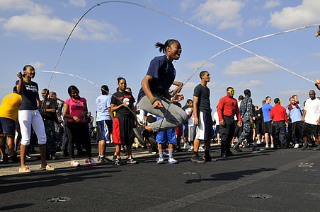 people standing near man playing skipping rope thumbnail
