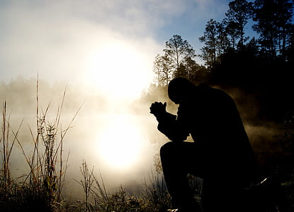 man sitting beside river thumbnail