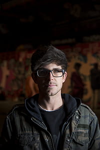 man wearing black framed eyeglasses and zip-up jacket thumbnail