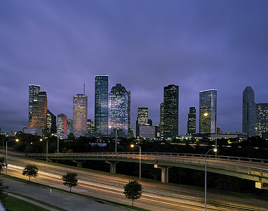 city buildings near road during nighttime thumbnail