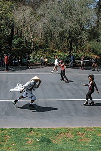 group of people roller skating on road thumbnail