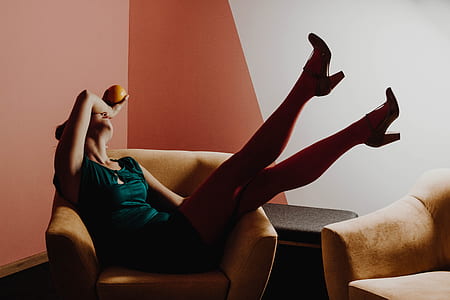 woman sitting on brown armchair thumbnail