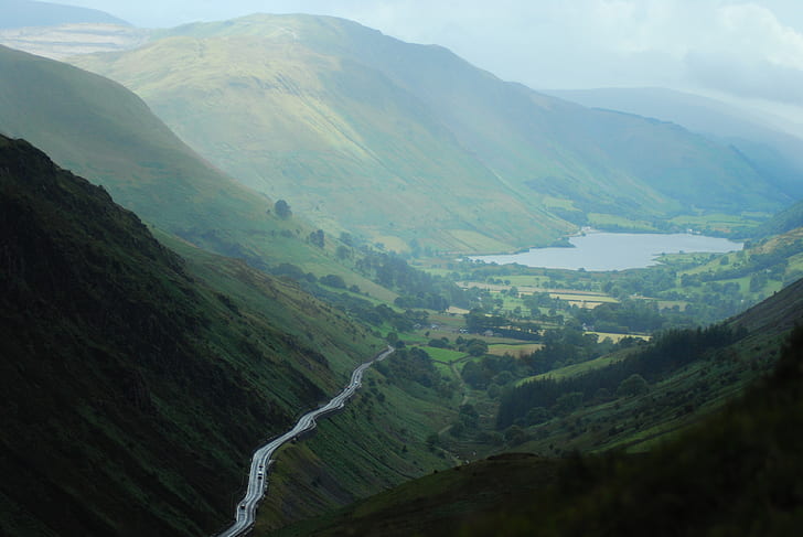 landscape photography of road beside mountains during daytime