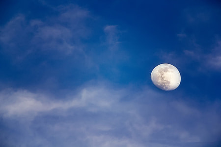 quarter moon with cloudy blue skies thumbnail
