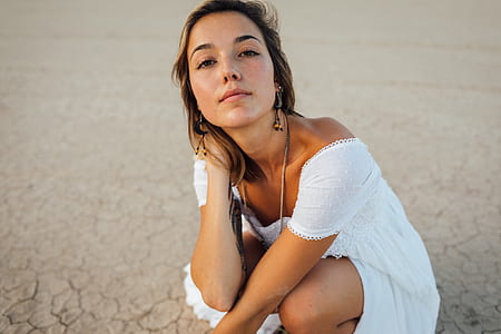 woman wearing white dress posing for a selfie thumbnail