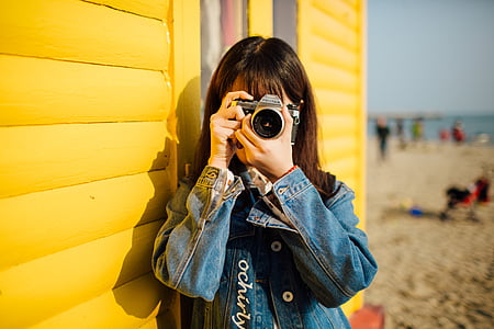 girl using black and silver point-and-shoot camera thumbnail