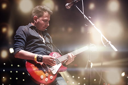 man playing red Les Paul electric guitar thumbnail