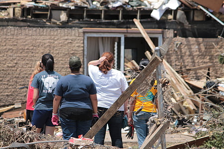 five women looking at wrecked house thumbnail