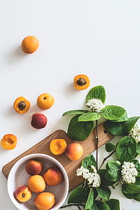 round orange fruits on white surface thumbnail