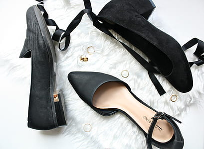 three unpaired black footwears on white textile thumbnail