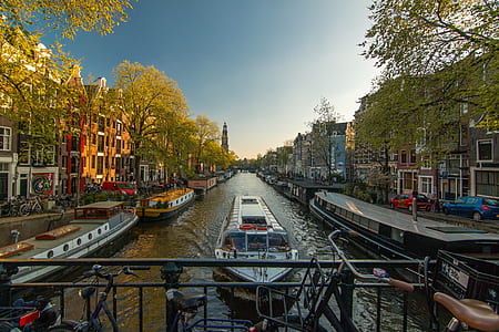 white boat in a river between buildings thumbnail