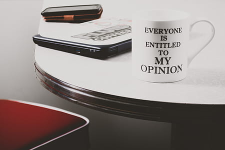 ceramic mug on table beside laptop thumbnail