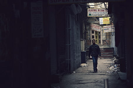 man standing between buildings thumbnail