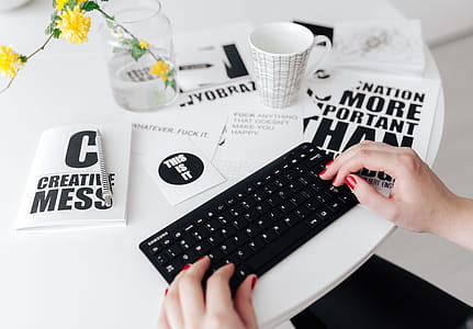 Female hands typing on the remote wireless computer keyboard thumbnail