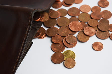 round coin lot beside bifold wallet thumbnail