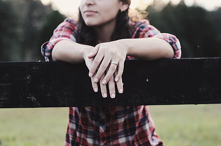 tilt-shift photography of woman behind fence thumbnail