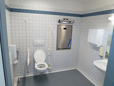 white ceramic flush toilet near white ceramic sink thumbnail