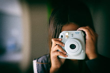 woman holding camera taking photo thumbnail