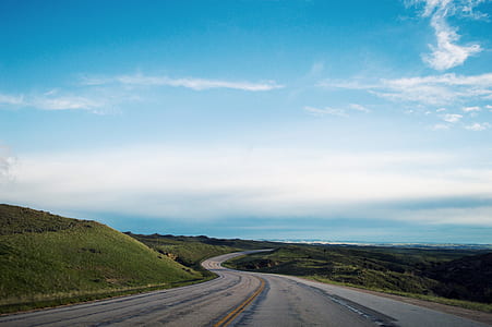 gray asphalt road under sunny sky thumbnail