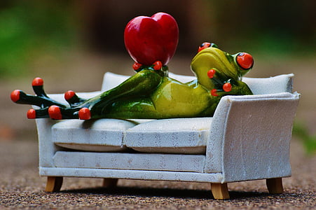 green ceramic frog figurine on couch during daytime thumbnail