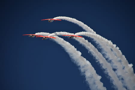 four bi-planes flying up in the sky performing airshow thumbnail