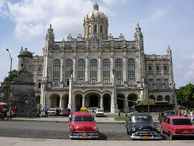 assorted-color-and-type vehicles parked near white concrete dome building thumbnail