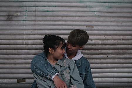 Boy Wearing Blue Denim Jacket and Embrace Woman Wearing Jacket thumbnail