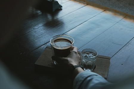 person holding clear glass mug thumbnail