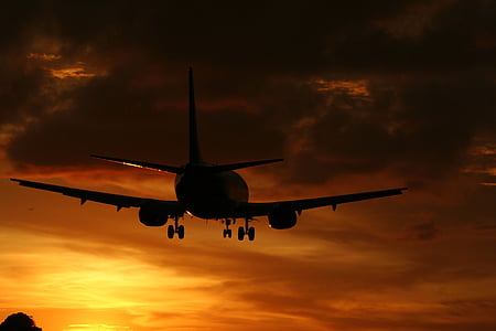 photo of plane under orange sky thumbnail