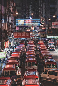 vehicles on road under Nikon signage thumbnail