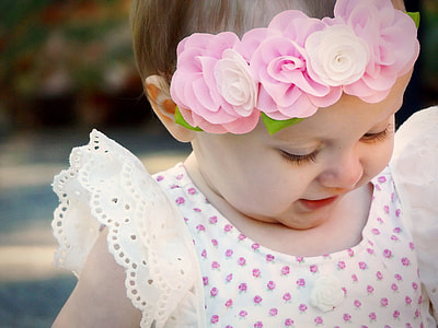 girl wearing pink and white polka dots dress and flower head dress thumbnail