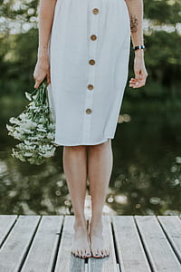 woman in white skirt on brown wooden dock thumbnail