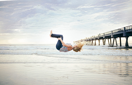Woman doing a Backflip on the Beach thumbnail