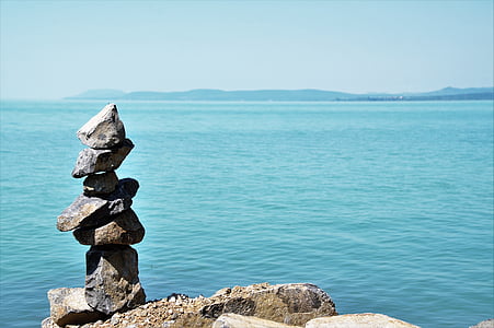 balanced of gray stone near body of water thumbnail