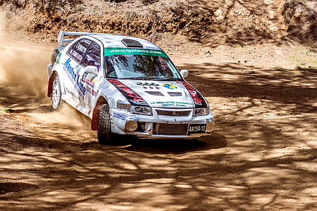 white Mitsubishi Lancer on brown soil thumbnail