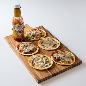 five meat dishes on brown wooden chopping board thumbnail