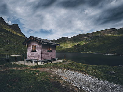 purple and black wooden house near mountain thumbnail