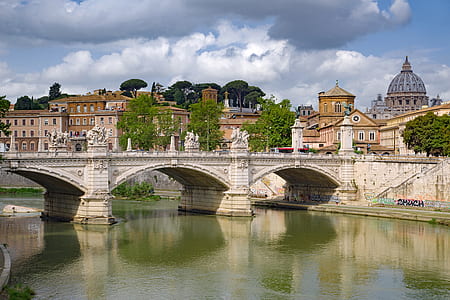 photo of gray concrete bridge near buildings thumbnail